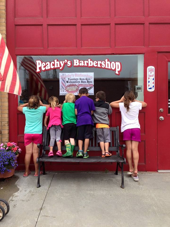Kids outside Peachy's Barbershop Woodbine Iowa